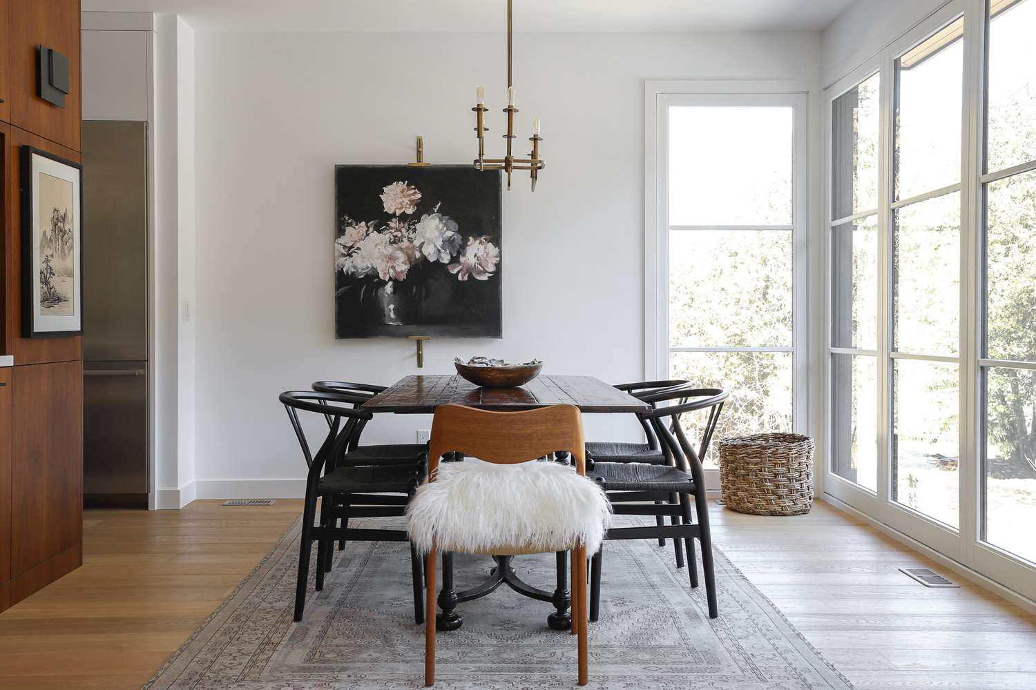 Modern dining room staging with minimalist design and floral artwork